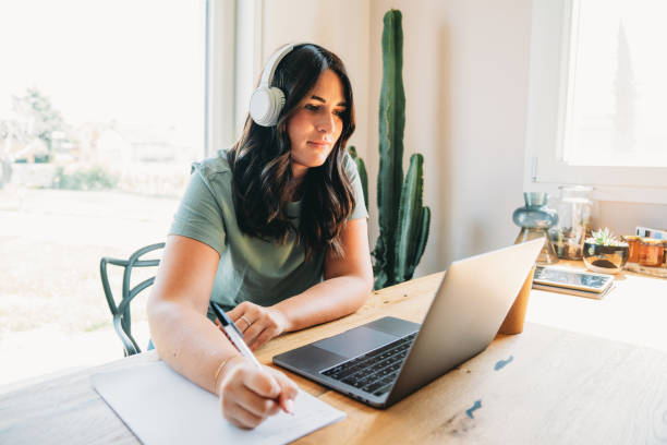 istock A woman is watching a webinar on her laptop 1471913407
