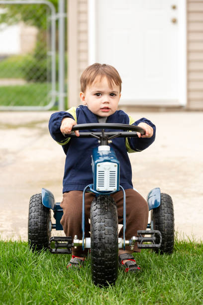 istock Boy On Toy Tractor In Back Yard 1471914725
