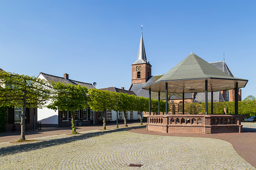 Village square with the reformed church in the village of Ingen in the Betuwe in the Netherlands.