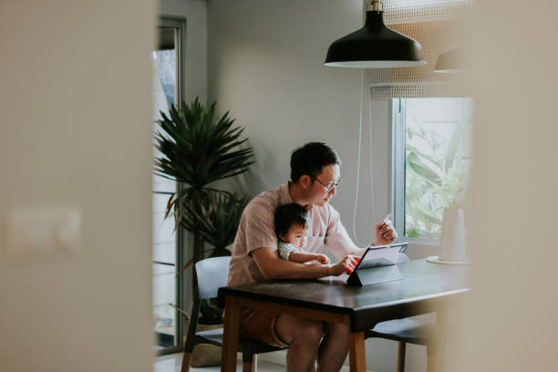 Girl excited when she saw her dad buying her some new toy. Baby girl sitting with her dad and looking while he trying to bu her some toy from online store. south east asia choicepix stock pictures, royalty-free photos & images