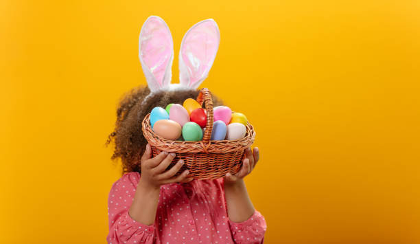 istock A Black girl carries a basket full of Easter eggs. Preparations for the Easter 1471918397