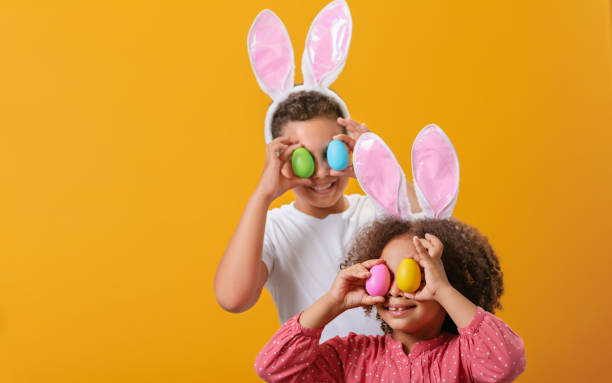 istock A happy children with rabbit ears on her head looking through Easter eggs 1471918405