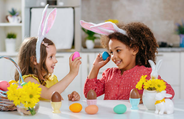 istock Two girls paint Easter eggs for holiday at home 1471918423