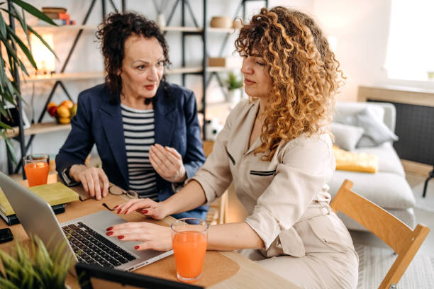 istock Mother and daughter work together from home 1471918699