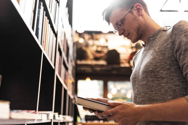 istock Student at the book shop looking for a book 1471918771