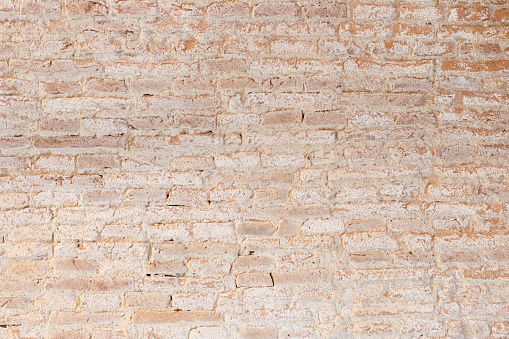 Background texture of old vintage dirty brick wall with white stains. Full frame