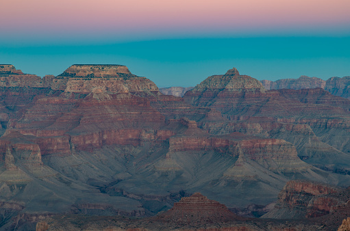 A picture of the landscape of the Grand Canyon National Park as seen from the south rim, Mather Point, at sunset.