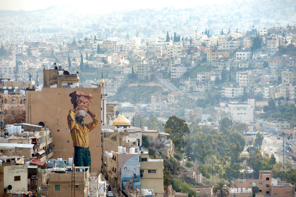 Amman cityscape from jabal al-qala’a hill with huge wall murals, Amman, Jordan stock photo