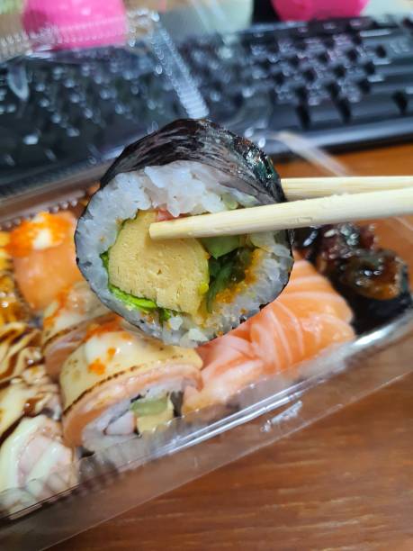 istock Eating Japanese food, picking up sushi using chopsticks. 1471925477