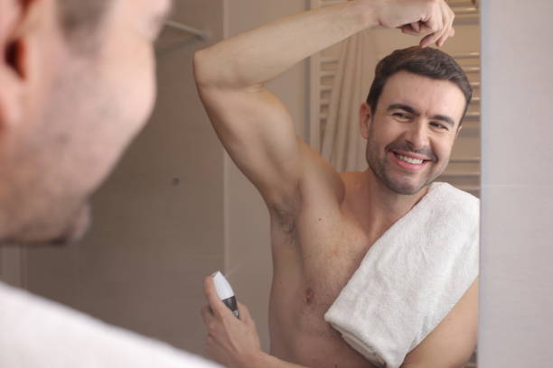 istock Man applying deodorant in the bathroom 1471925658