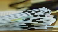istock Fingers fingering a large stack of paper documents. 1471925710