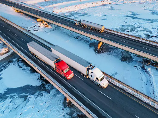 Photo of Semi Trucks Crossing Frozen River