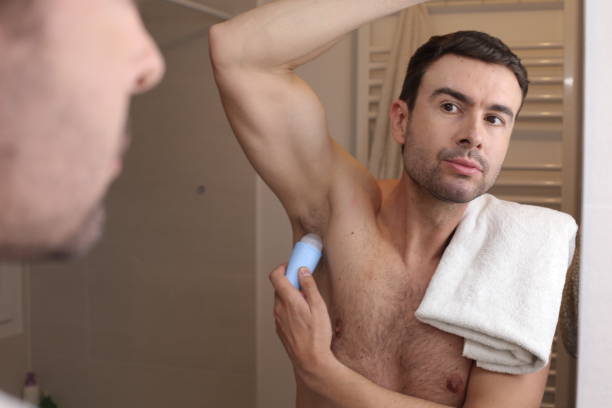 istock Man applying deodorant in the bathroom 1471927265