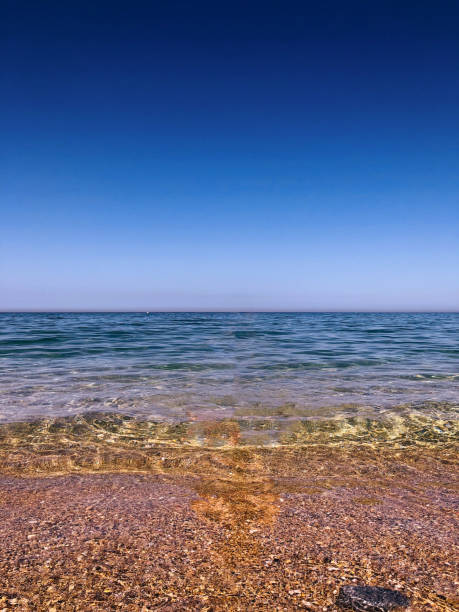 Serene sea clear waters a tranquil, mirror-like reflection Serene sea clear waters a tranquil, mirror-like reflection harmoniousness stock pictures, royalty-free photos & images