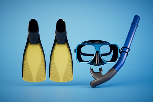 Set of swim fins, mask and snorkel for diving isolated on blue background. 3d render.