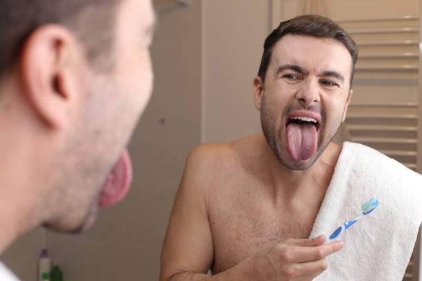 Man examining his own tongue stock photo