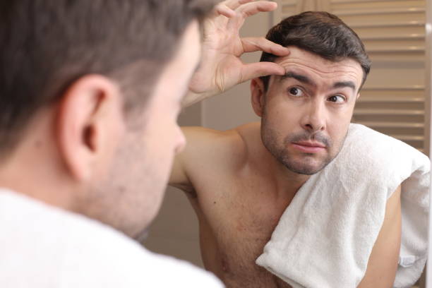 istock Man observing his image in the mirror 1471933978