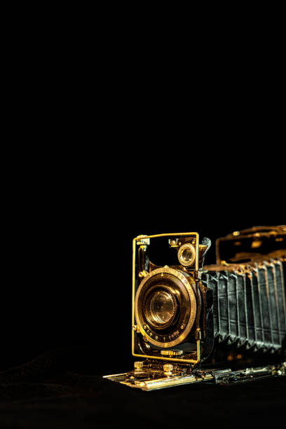 istock Antique fold photocamera on black background 1471935616