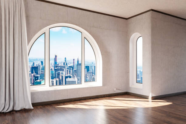 istock empty luxurious loft apartment with arched window and panoramic view over urban downtown; noble interior design mock up with white curtain and wooden floor; 3D Illustration 1471936330