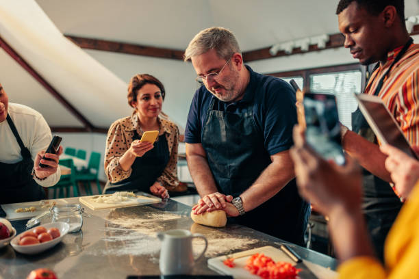 istock Chef making dough student recording with mobile phones. 1471936513
