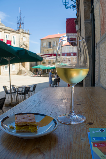 Ribadavia is a town and municipality located in the southwest of the province of Ourense, autonomous community of Galicia, Spain on August 20, 2022. Glass of Albariño wine at  the main square.