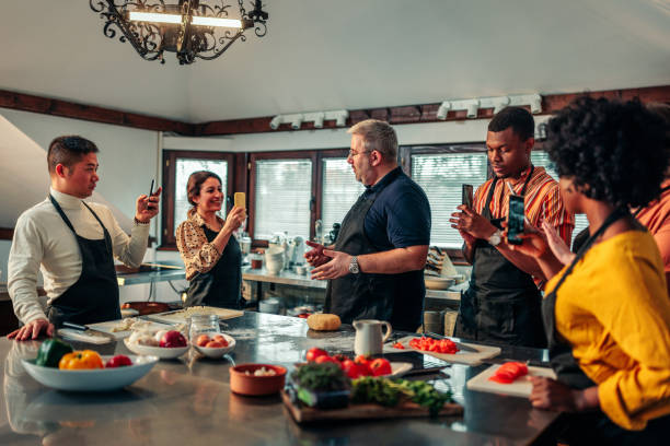 istock Students recording teacher in cooking class. 1471936846