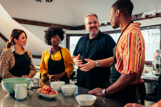 istock Cheerful teacher with students in cooking class. 1471939302