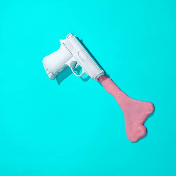 istock Creative minimalist layout. Gun with slime on a blue background. Surreal summer idea. Conceptual pop 1471940511