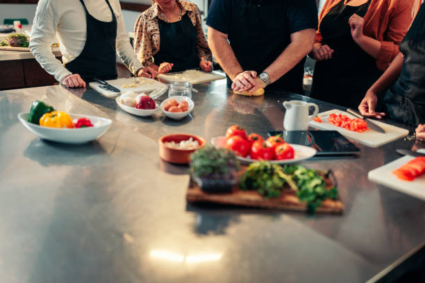 istock Close up on mans hands makin dough in cooking class. 1471941644