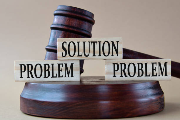istock SOLUTION, PROBLEM, PROBLEM - words on wooden blocks against the background of a judge's gavel with a stand. 1471941697