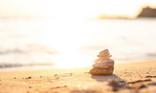 Pebbles on the beach, stacked on top of each other.