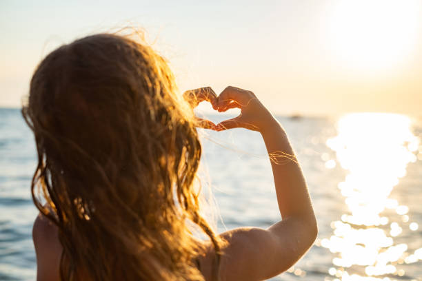 istock A little girl makes a heart with her hands. 1471944506