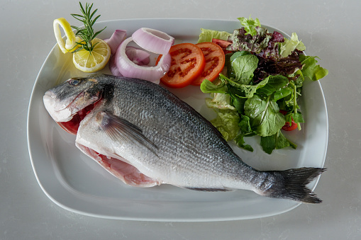 A plate of  sea bream with salad