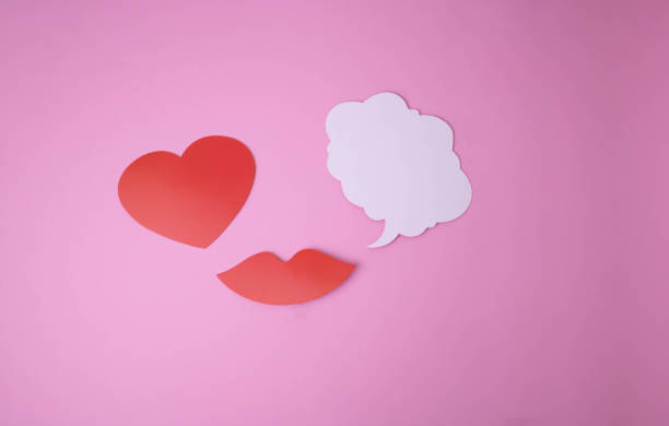istock On a pink background paper red lips and a heart and a white cloud for words. 1471949154