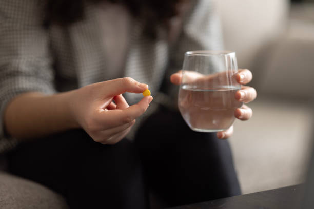istock Woman medicating himself at home medicine 1471949500