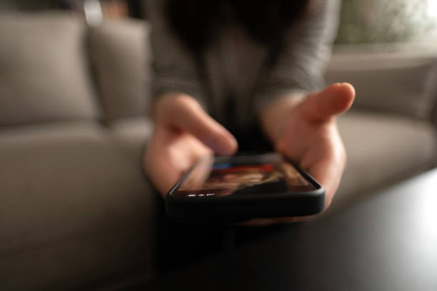 Hand scrolling through photos on smart phone