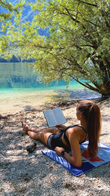 Enjoying a good read on the peaceful lake shore