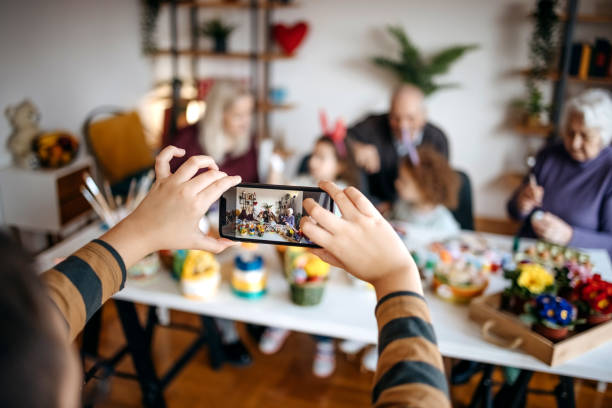 Multi-Generation Family preparing decoration for Easter holiday together at home
