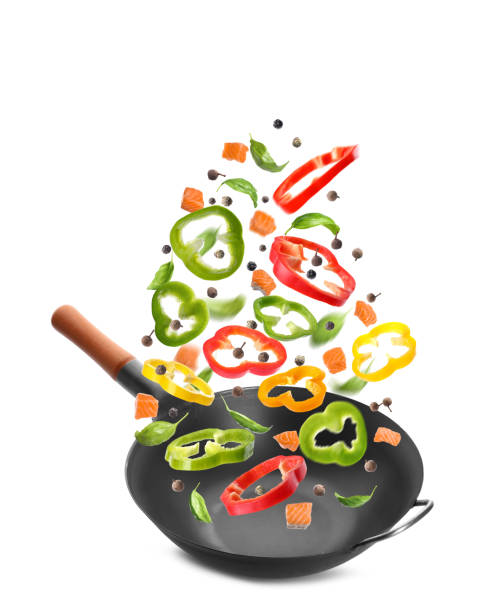 istock Different tasty ingredients falling into wok on white background 1471954254