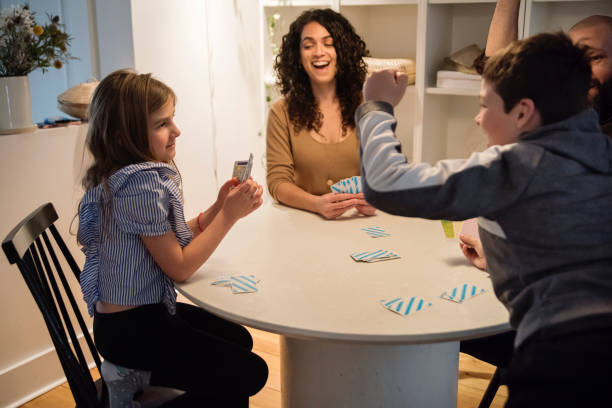 istock Family time on week-end at home playing cards. 1471955221