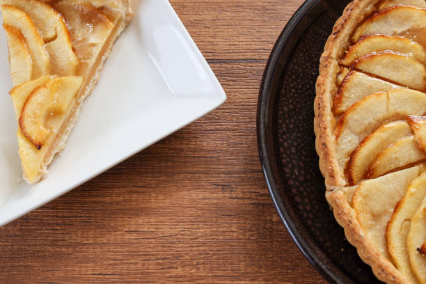 istock Apple tart on a plate isolated on a wooden table. 1471955351