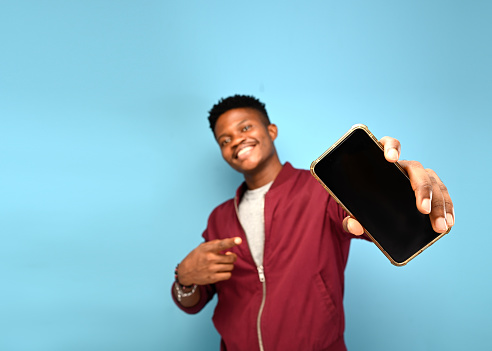 African American Man Smiling To Camera Posing Over Studio Background. Phone Mockup