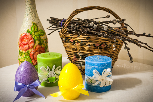 Easter candles with basket and willow branches