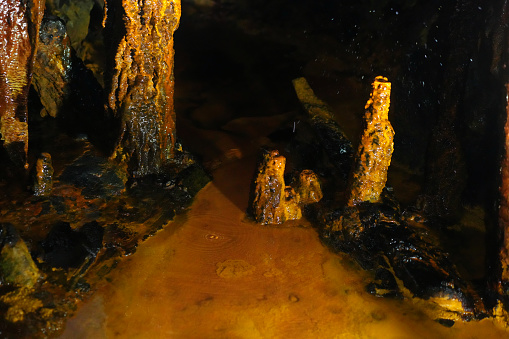 The magical underground environment from picturesque different minerals as limonite dripstones creating stalagmites, stalactites, and stalactite spaghetti.