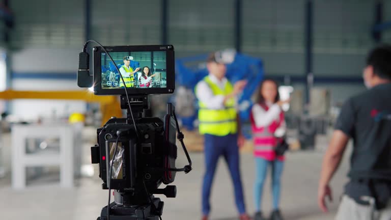 4K Male And Female Engineer checking robot arm movement for quality control of automated production line at modern factory