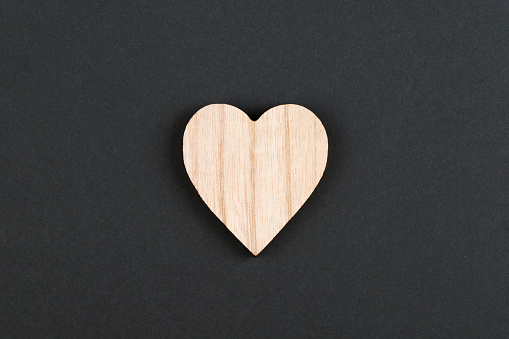 Wooden hearts, one red heart on the wooden heart background.