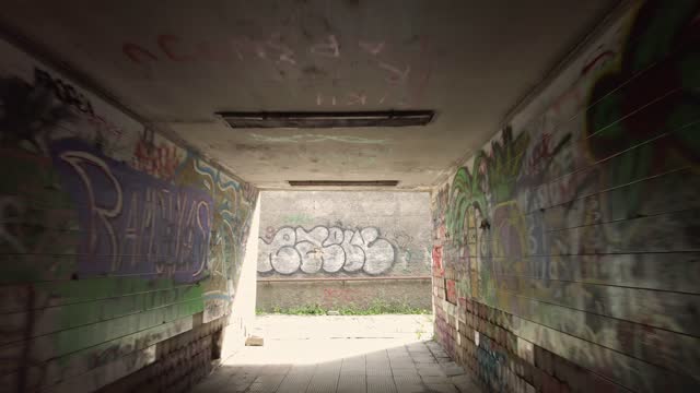 Pedestrian underpass with graffiti, shooting with gimbal