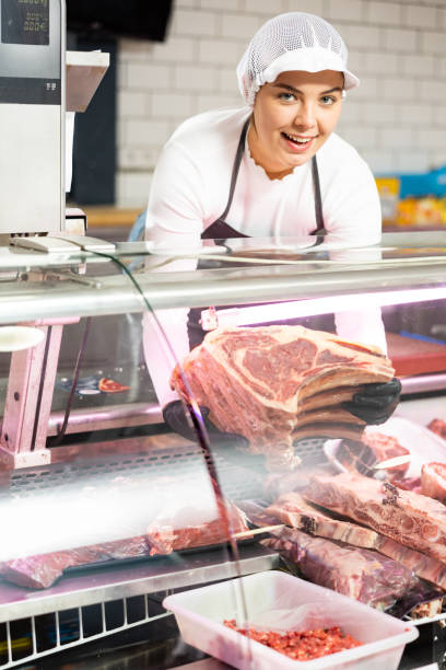 istock Young woman puts beef ribs in showcase 1471970603