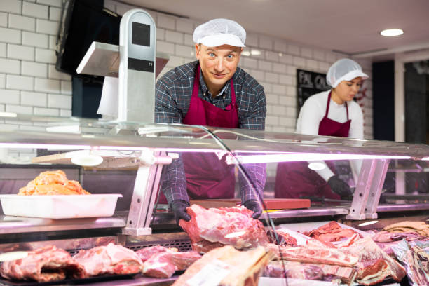 istock Adult man puts beef ribs in showcase 1471970632