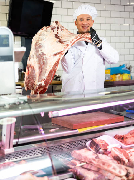 istock Adult man puts beef ribs in showcase 1471970698